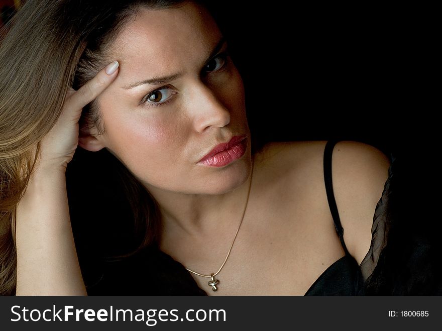 Beautiful brunette portrait over dark background. Beautiful brunette portrait over dark background