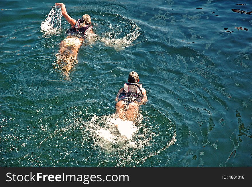 Two girls swimming by in Lake Washington, Seattle. Two girls swimming by in Lake Washington, Seattle