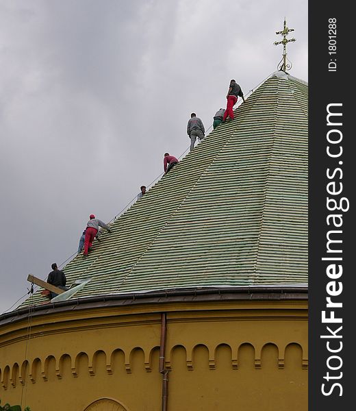 People working on the roof of the church