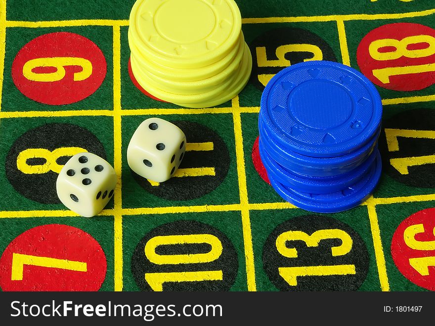 Casino still life. Dice, numbers, blue and yellow chips background. Casino still life. Dice, numbers, blue and yellow chips background.