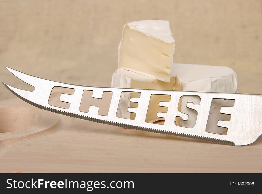 Cheese on a cutting board with knife