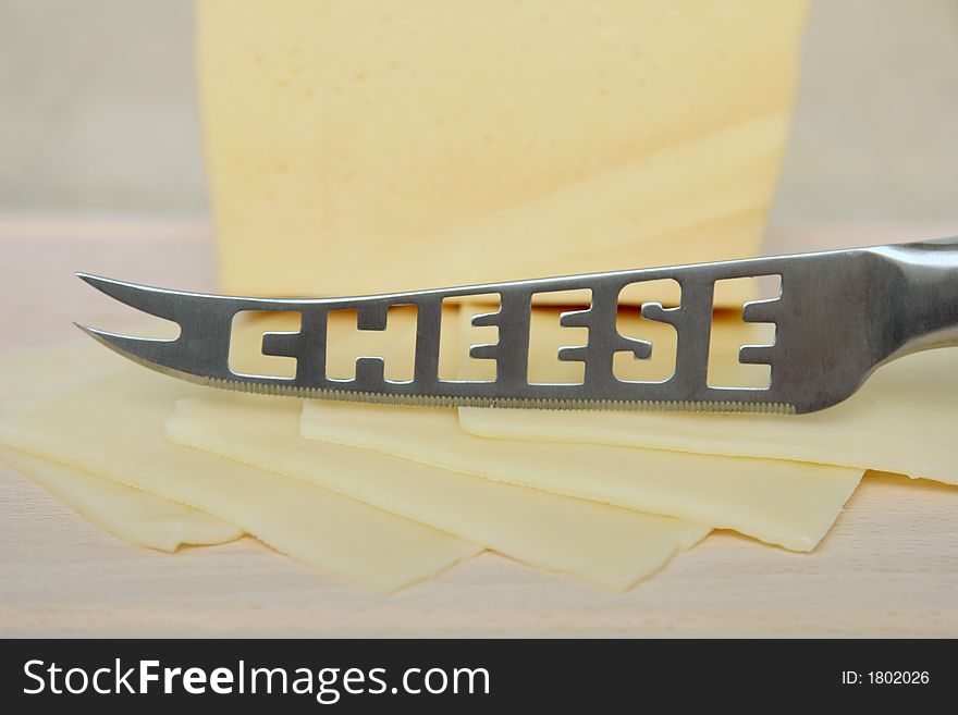 Cheese on a cutting board with knife