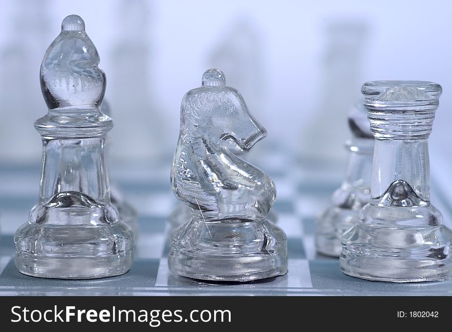 Three figures of a glass chess game