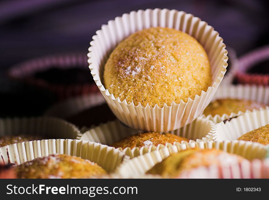 Freshly baked home-made cupcakes with powdered sugar on top. Freshly baked home-made cupcakes with powdered sugar on top