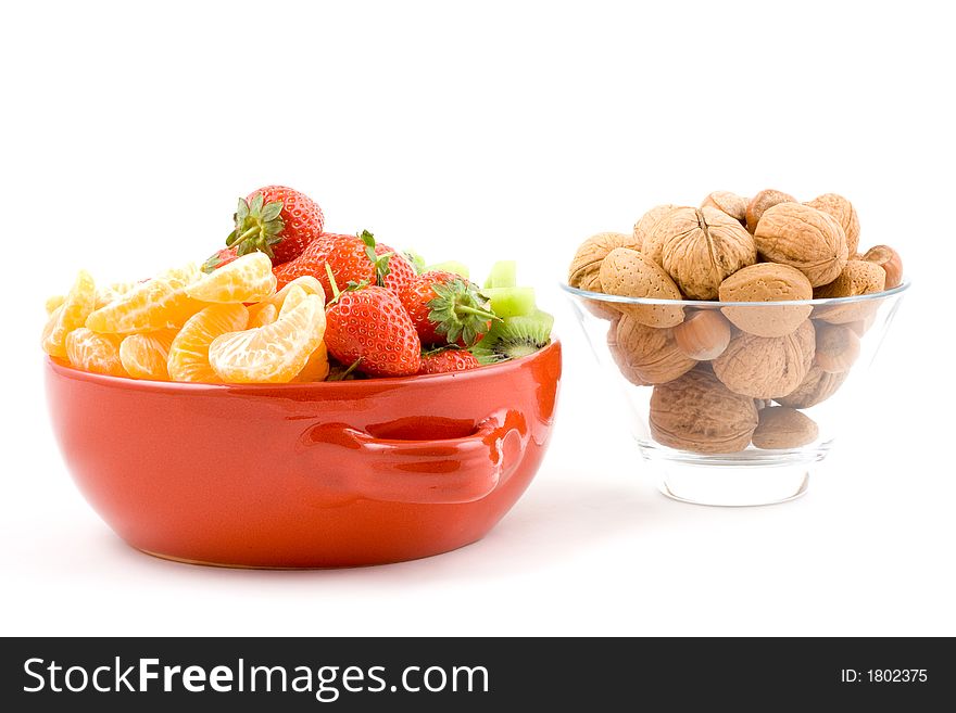 Kiwi, strawberry and mandarine, tangerine with mixed nuts on white background, isolated