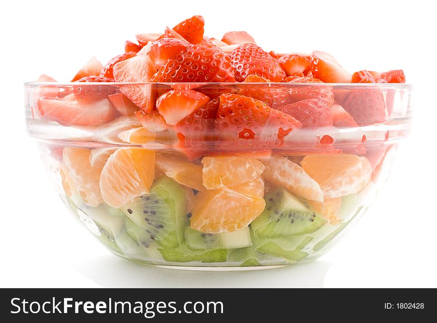 Strawberry kiwi and tangerines in transparent bowl on white background, isolated. Strawberry kiwi and tangerines in transparent bowl on white background, isolated