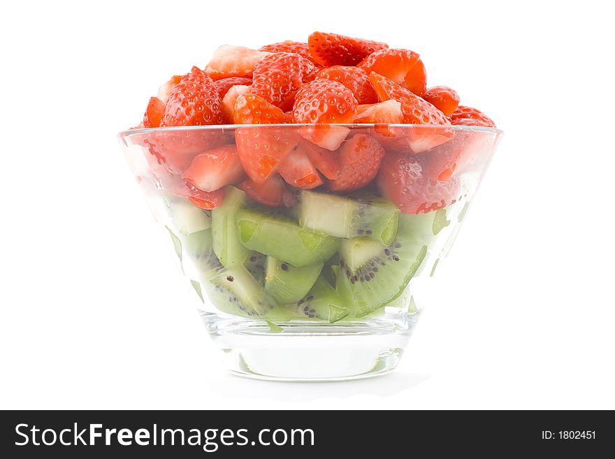 Green and red - kiwi and strawberries in small transparent bowl. Isolated. On white background