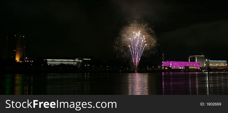 Fireworks in Linz (Austria) at the Danube river with beautiful reflections. On the right side the Brucknerhaus (orchestra house) on the left the Lentos (Museum) with its illuminated walls. Fireworks in Linz (Austria) at the Danube river with beautiful reflections. On the right side the Brucknerhaus (orchestra house) on the left the Lentos (Museum) with its illuminated walls.