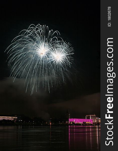 Fireworks in Linz (Austria) at the Danube river with beautiful reflections. On the right side the Brucknerhaus (orchestra house) on the left the Lentos (Museum) with its illuminated walls. Fireworks in Linz (Austria) at the Danube river with beautiful reflections. On the right side the Brucknerhaus (orchestra house) on the left the Lentos (Museum) with its illuminated walls.