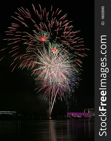 Fireworks in Linz (Austria) at the Danube river with beautiful reflections. On the right side the Brucknerhaus (orchestra house) on the left the Lentos (Museum) with its illuminated walls. Fireworks in Linz (Austria) at the Danube river with beautiful reflections. On the right side the Brucknerhaus (orchestra house) on the left the Lentos (Museum) with its illuminated walls.