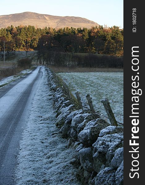 Winter Road with icey stone wall