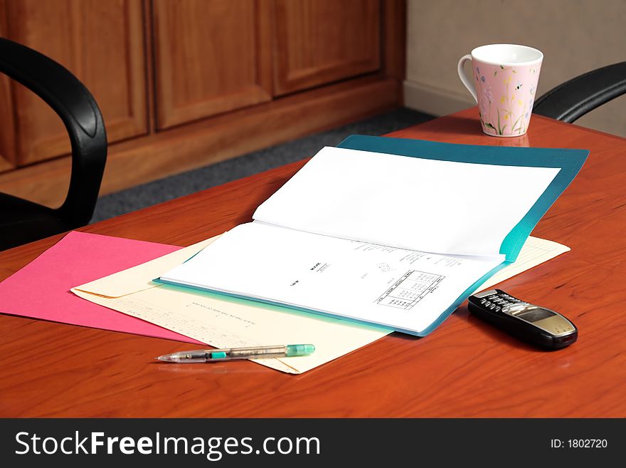 Board room table with files and a cup of coffee. Board room table with files and a cup of coffee