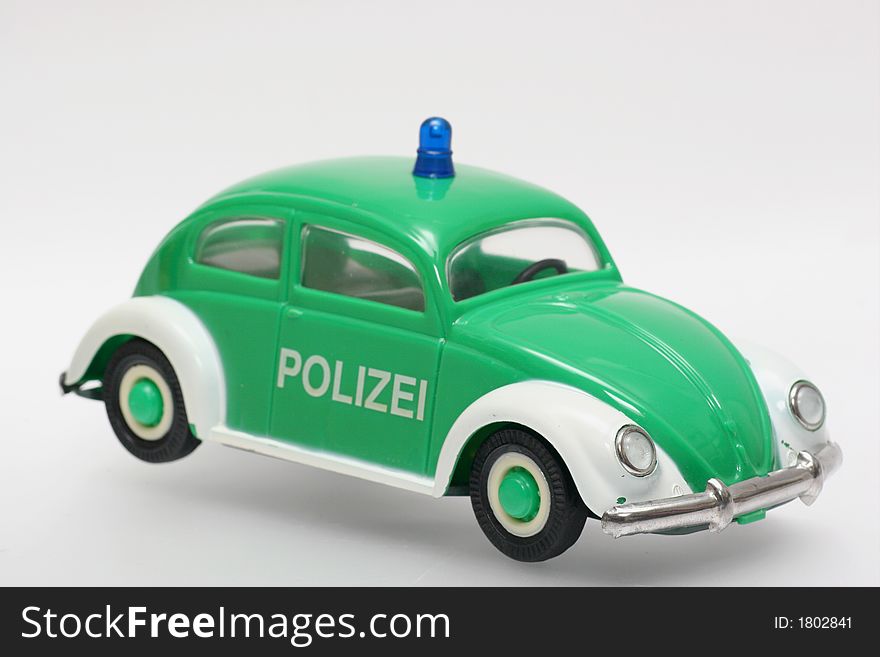 Old plastic police car. German police VW Beatle like Germany used to have in the 70's. One of the many thousand toys my brother is collecting. Toy is from the 70's or 80's. Old plastic police car. German police VW Beatle like Germany used to have in the 70's. One of the many thousand toys my brother is collecting. Toy is from the 70's or 80's.