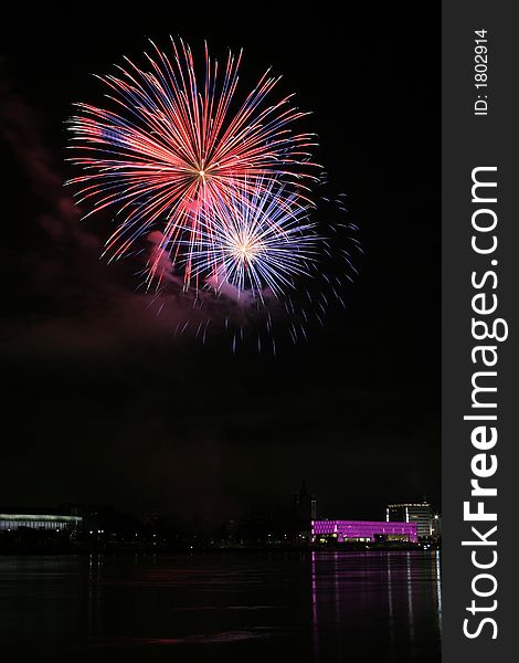 Fireworks in Linz (Austria) at the Danube river with beautiful reflections. On the right side the Brucknerhaus (orchestra house) on the left the Lentos (Museum) with its illuminated walls. Fireworks in Linz (Austria) at the Danube river with beautiful reflections. On the right side the Brucknerhaus (orchestra house) on the left the Lentos (Museum) with its illuminated walls.