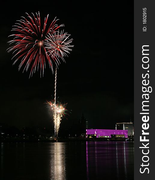 Fireworks in Linz (Austria) at the Danube river with beautiful reflections. On the right side the Brucknerhaus (orchestra house) on the left the Lentos (Museum) with its illuminated walls. Fireworks in Linz (Austria) at the Danube river with beautiful reflections. On the right side the Brucknerhaus (orchestra house) on the left the Lentos (Museum) with its illuminated walls.