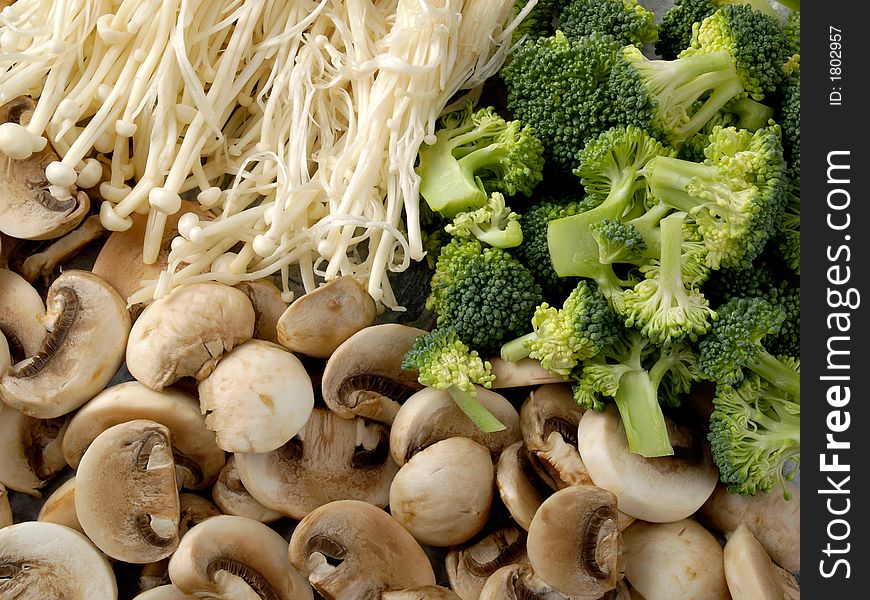 Two types of mushrooms and some broccoli. Two types of mushrooms and some broccoli