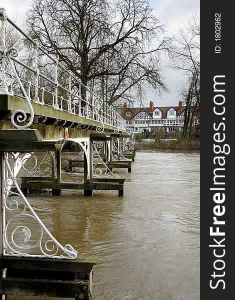 Victorian Footbridge over a Swollen River Thames in Winter