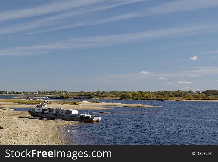 The boat on sand coast in russian province.