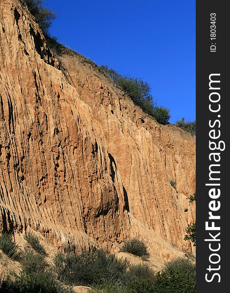 Orange colored dirt cliffs in California. Orange colored dirt cliffs in California