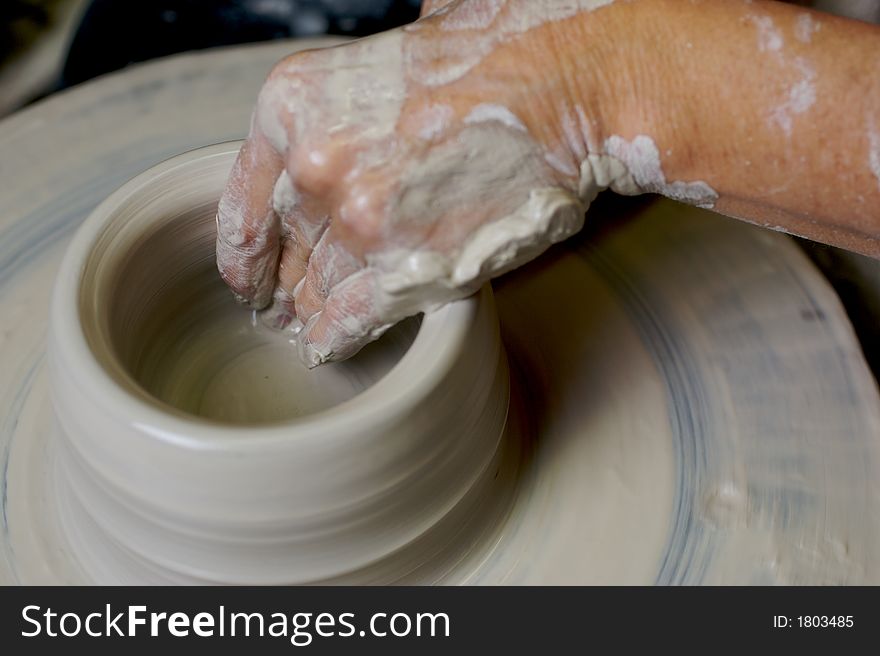 Potter working clay