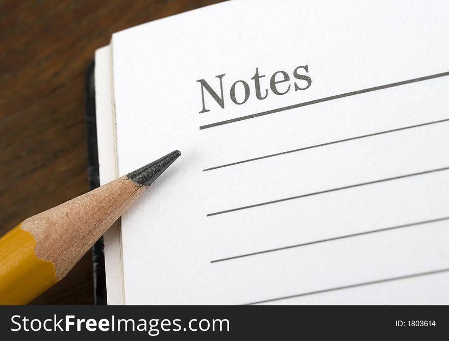 Closeup image of pencil and notepad. Closeup image of pencil and notepad.