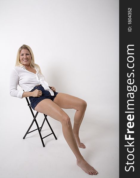 Pretty blond girl relaxing in a chair