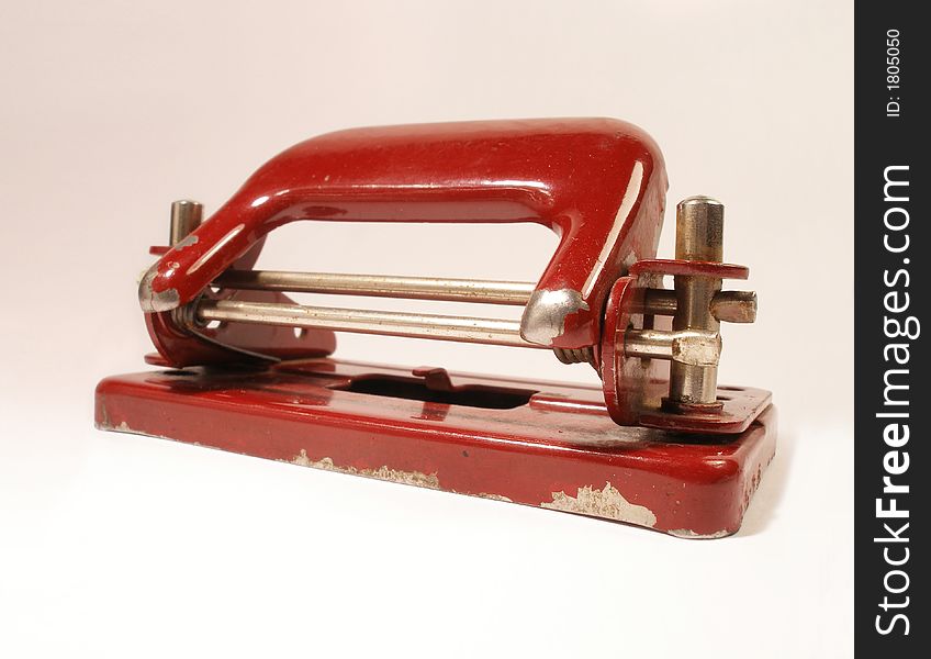 Red vintage metal puncher looks used and really old