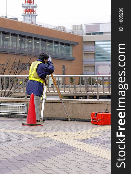 Urban topographer doing measurements in a big city.