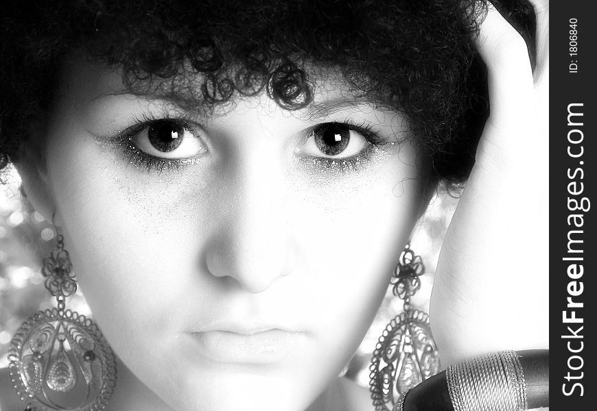 Beautiful young woman with curly black hair in black and white. Beautiful young woman with curly black hair in black and white.