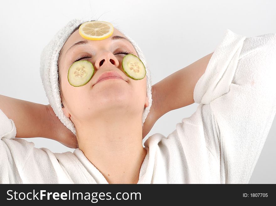 Attractive woman with fruits on face on white background. Attractive woman with fruits on face on white background