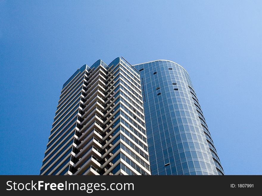 Modern skyscrapers against a bright blue sky