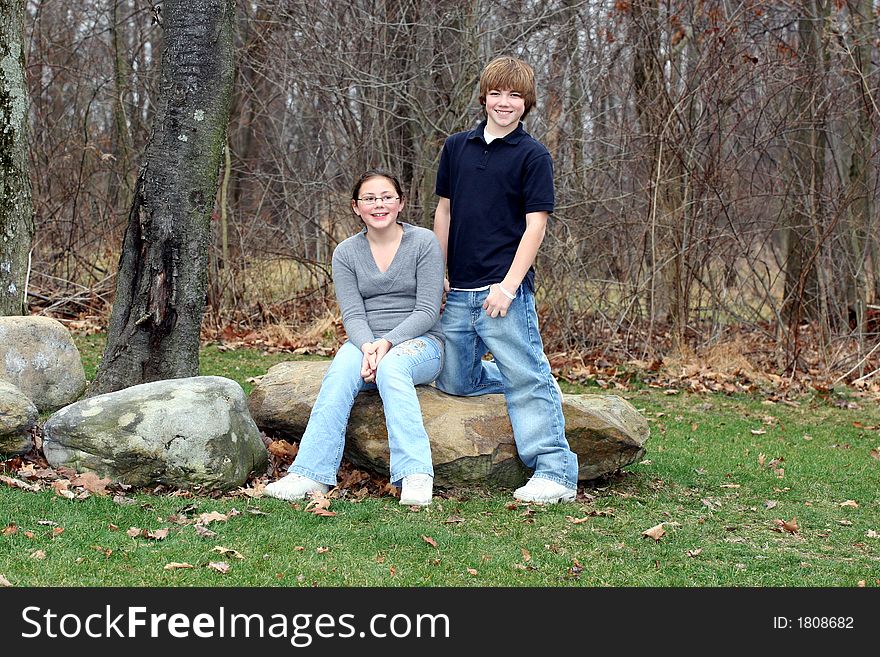 Young happy teen siblings in park like setting. Young happy teen siblings in park like setting.