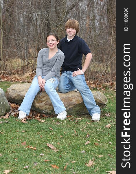 Young happy teen siblings in park like setting. Young happy teen siblings in park like setting.