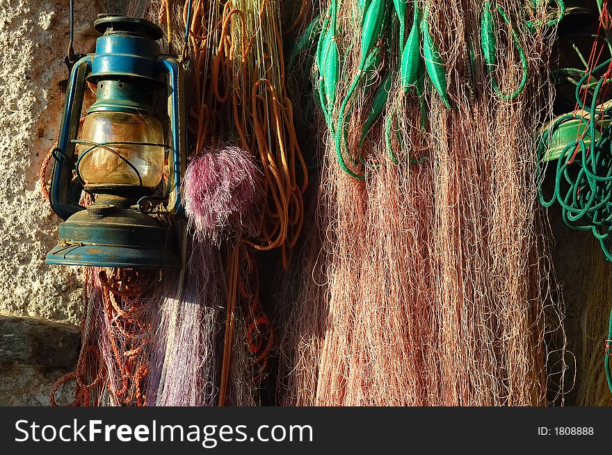 Fish net and old oil lamp. Fish net and old oil lamp