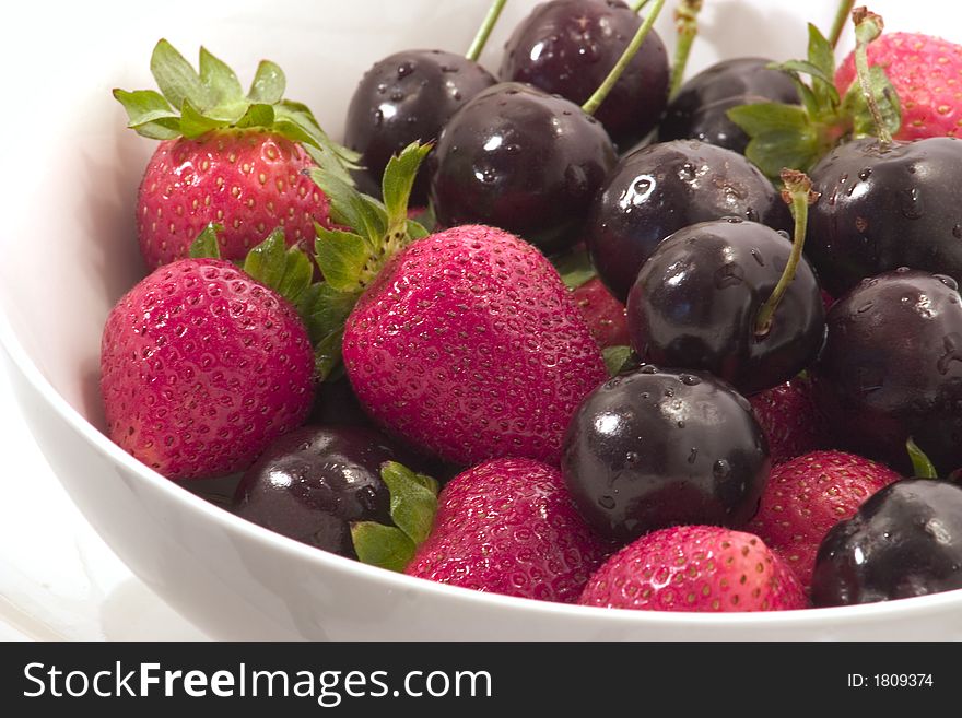 Starwberries and cherries in a bowl. Starwberries and cherries in a bowl