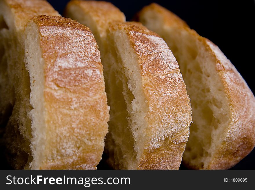 A loaf of bread that has been cut into slices. A loaf of bread that has been cut into slices.