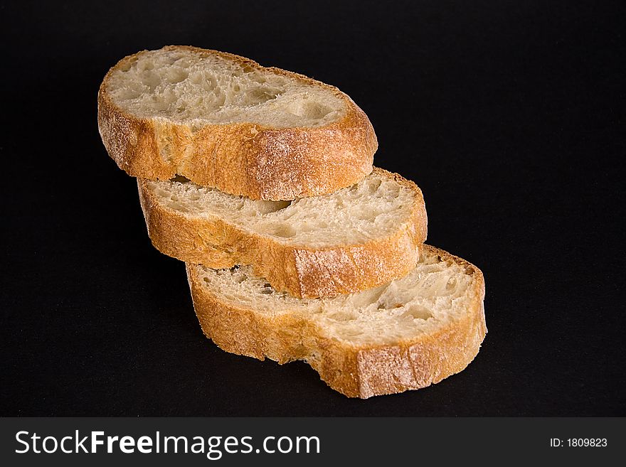 A loaf of bread that has been cut into slices. A loaf of bread that has been cut into slices.