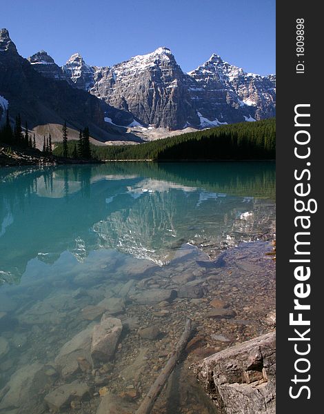 Clear blue water of lake morraine in canada with majestic mountain backdrop. Clear blue water of lake morraine in canada with majestic mountain backdrop