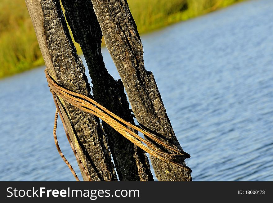 Partially Burned Pier Post in Delta Waterway, San Joaquin Valley, California. Partially Burned Pier Post in Delta Waterway, San Joaquin Valley, California