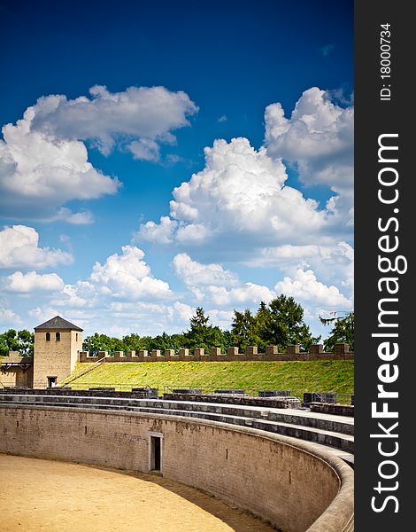 Old roman Amphitheatre, arena with blue sky and clouds