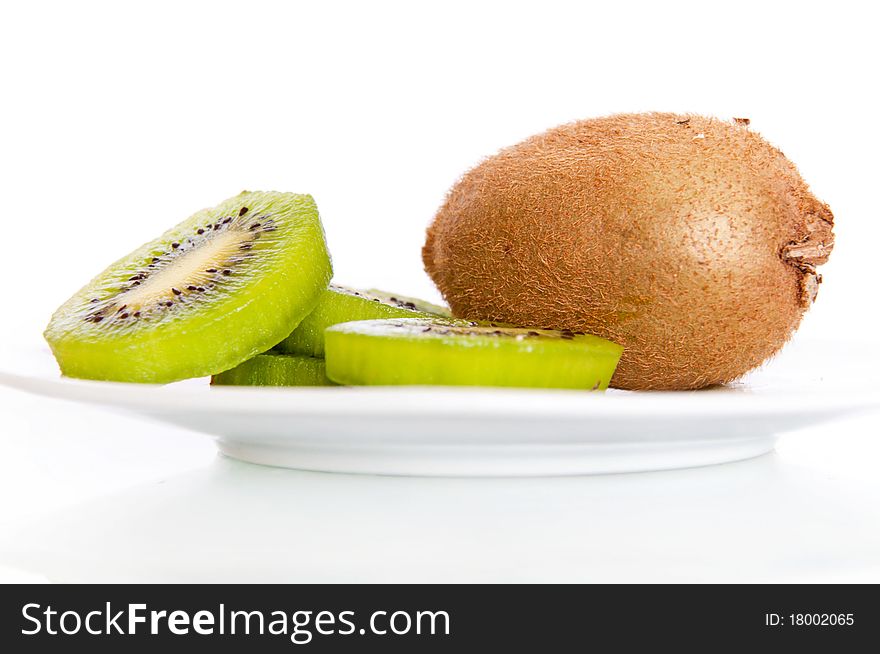 A plate with fresh kiwi isolated on white background