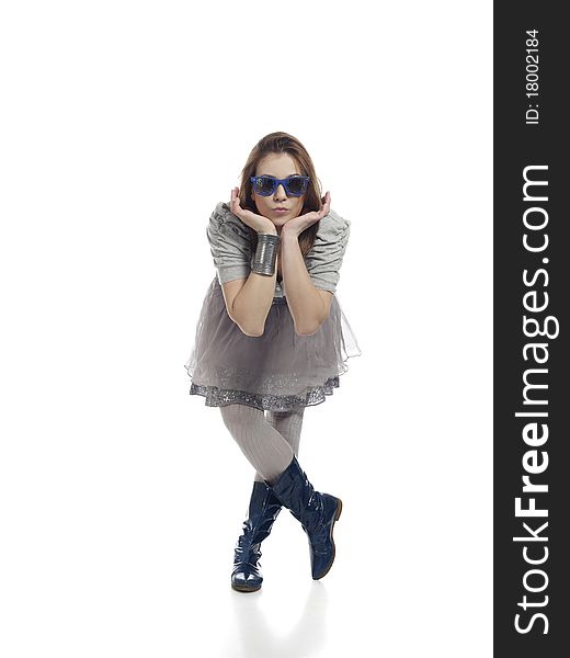 Young woman in cool clothes posing, holding her head with her hands against white background. Young woman in cool clothes posing, holding her head with her hands against white background