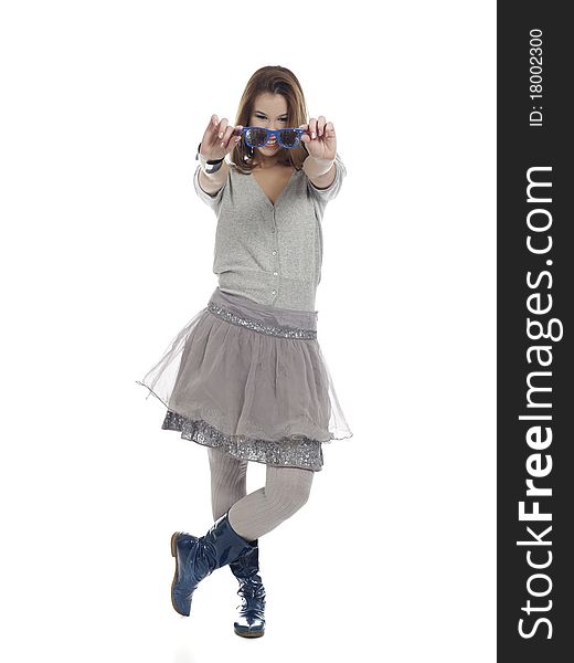 Young confident woman in cool clothes holding sunglasses in front of herself. Young confident woman in cool clothes holding sunglasses in front of herself