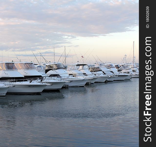 Row of docked boats and yachts at Sunset