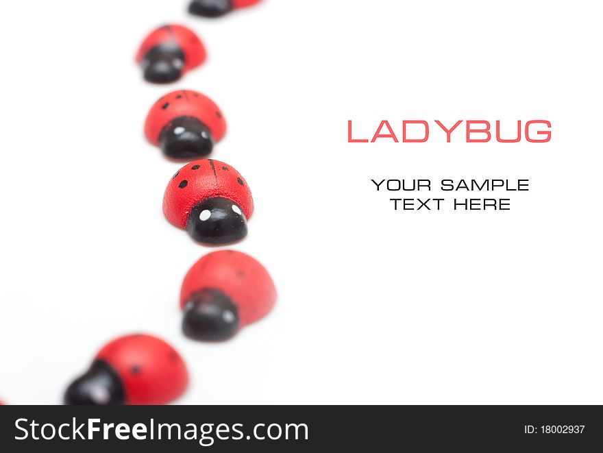 Small decorative ladybugs on a white background with space for text. Small decorative ladybugs on a white background with space for text