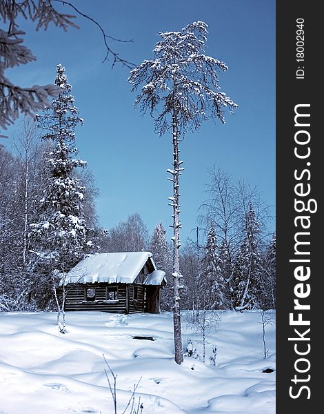 Winter rural landscape with old house