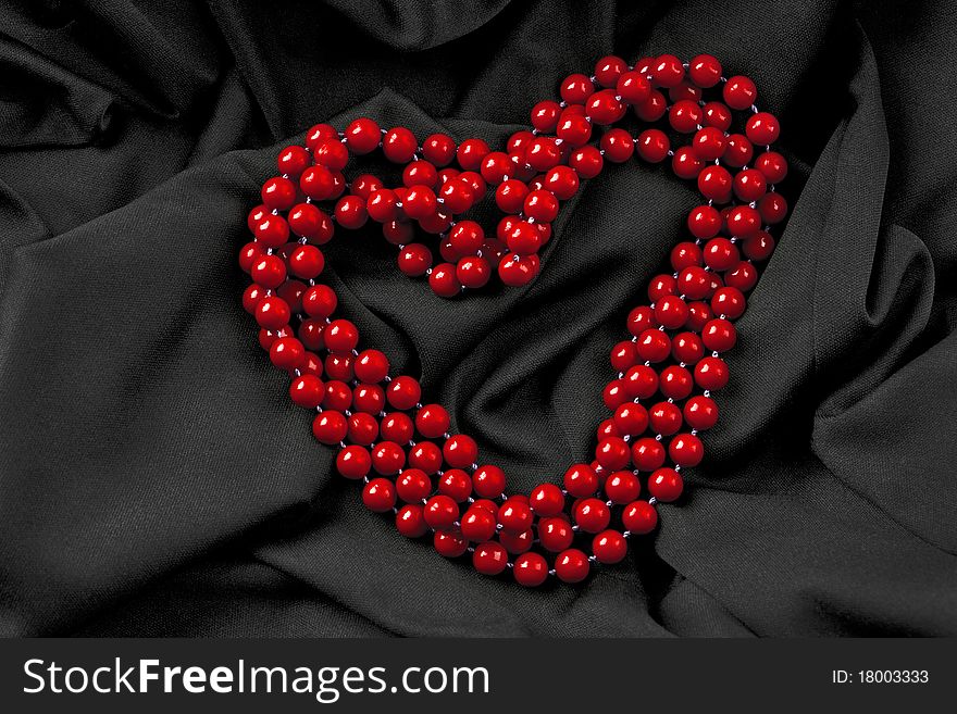 Beads in heart shape on the fabric