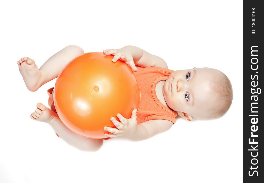 Small beautiful baby boy with ball on a white background