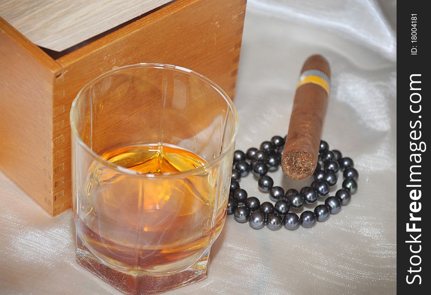 Cigars, cognac and black pearls. Cigars, cognac and black pearls.