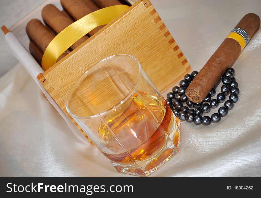 Cigars, cognac and black pearls. Cigars, cognac and black pearls.